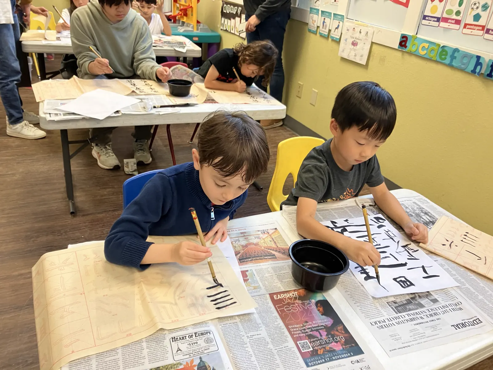 APLS student practicing Chinese calligraphy with brush and ink