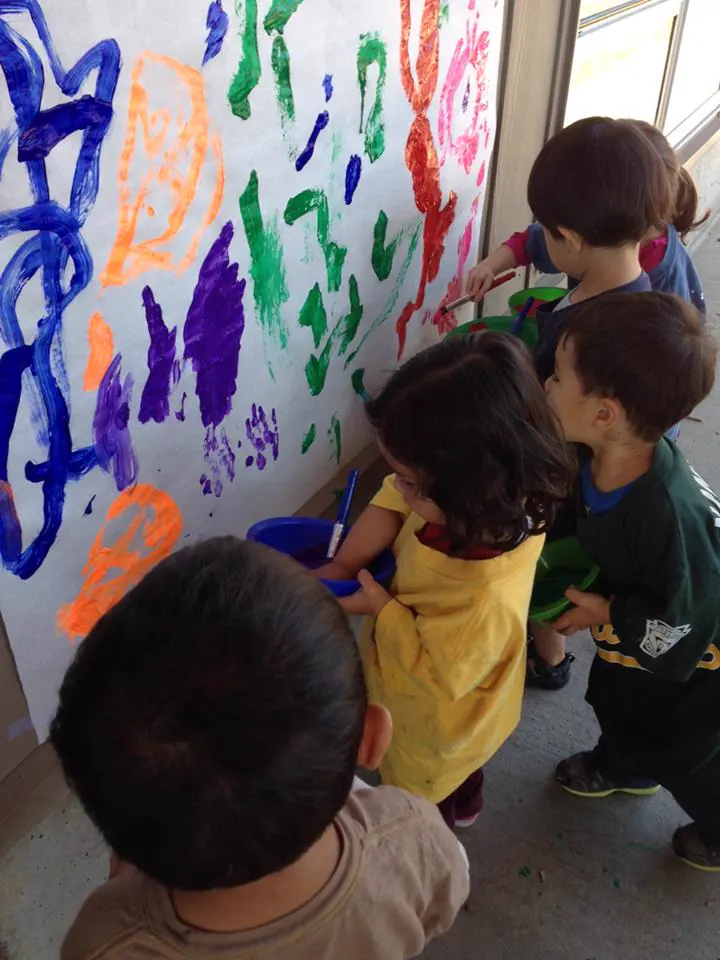 Preschoolers painting during an APLS arts activity