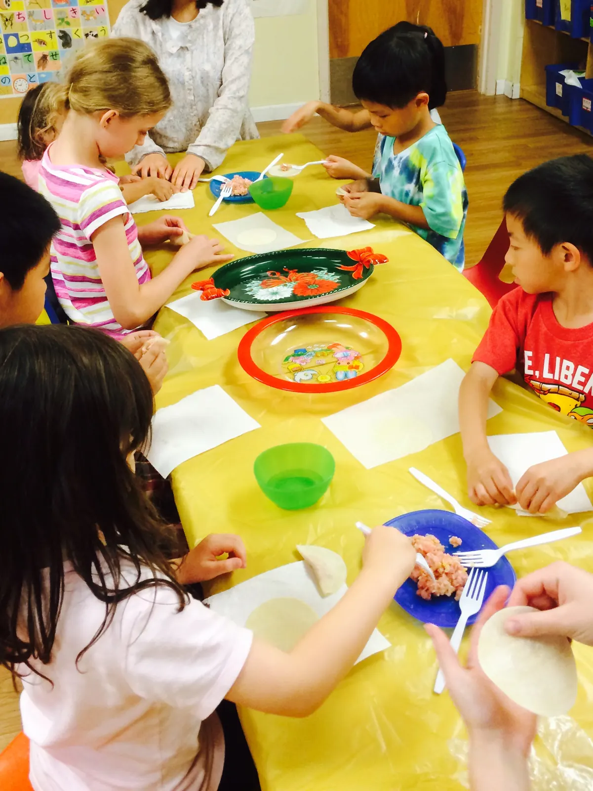 Children making dumplings together during a cultural cooking activity
