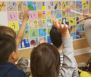 Young learners practicing Japanese hiragana characters